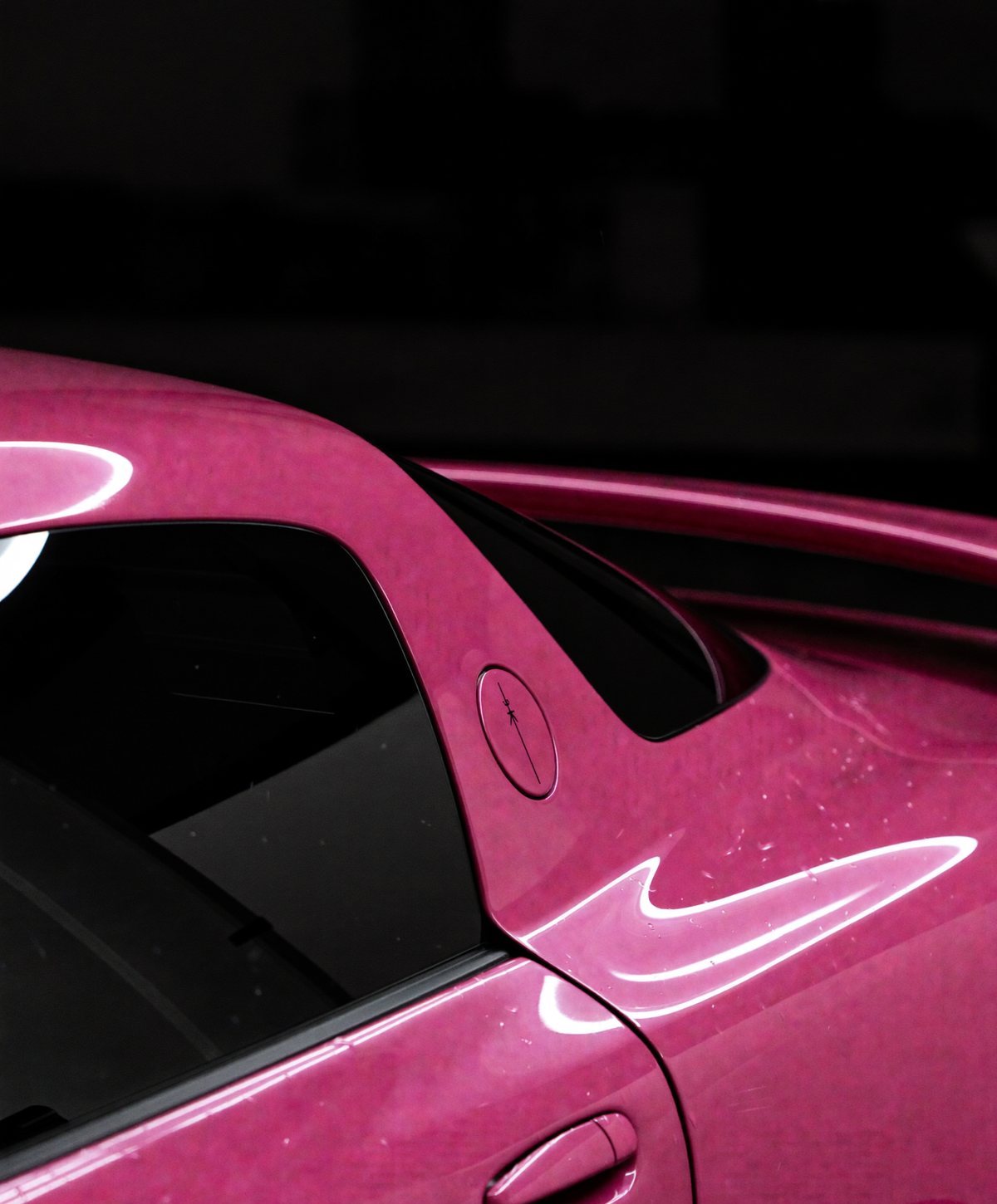 Freshly wrapped Interstellar Pink hatchback outside the shop at dusk